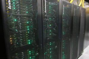 Large supercomputer with green lights.
